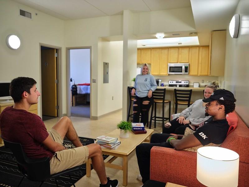 Students in a room talking in a group