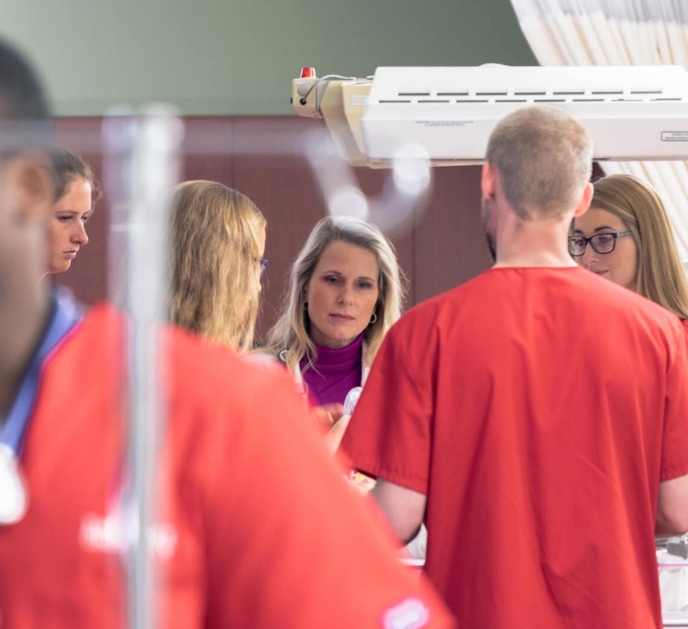 Nursing professor in simulation lab with students