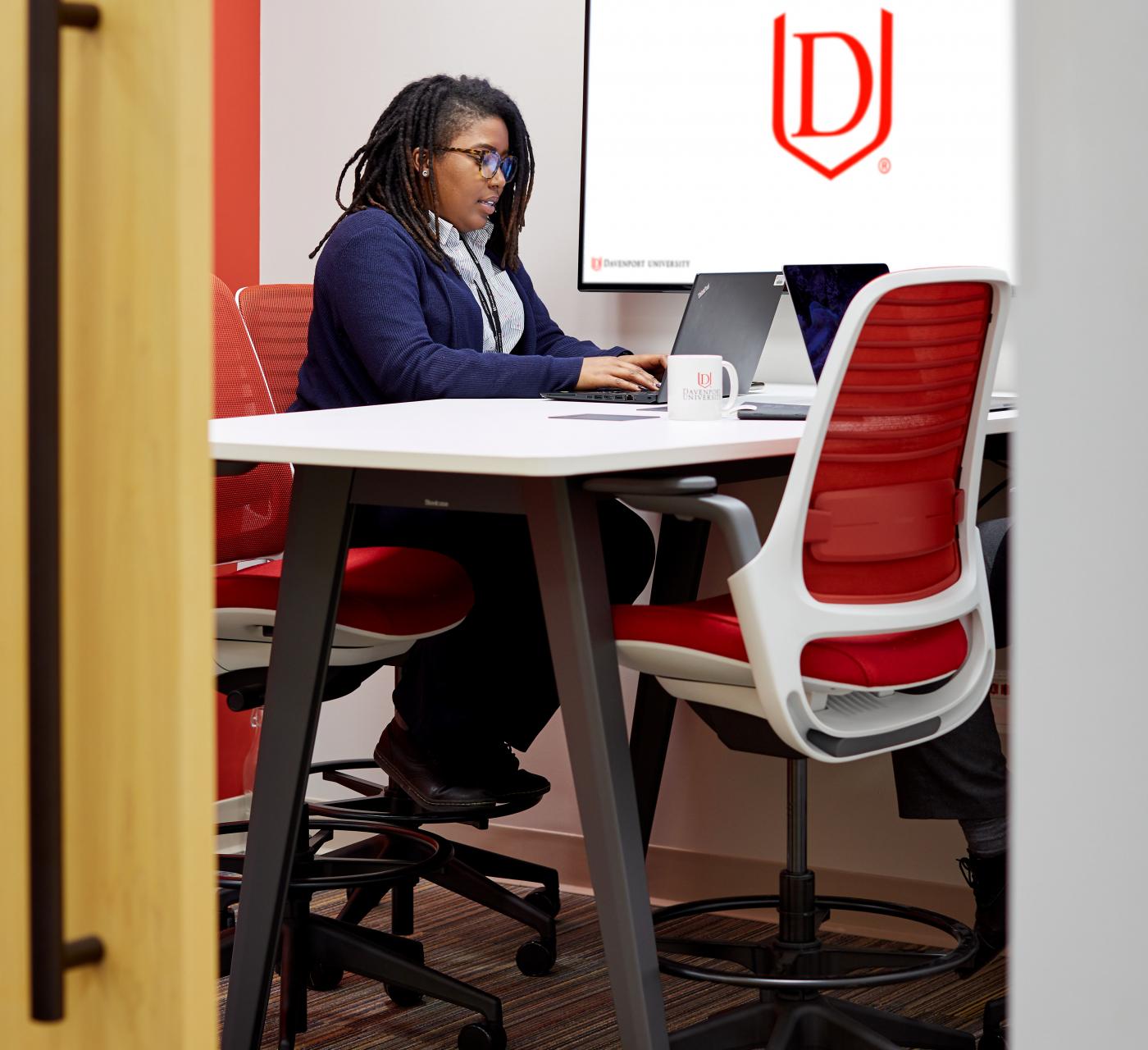 Female student studying in a study room on the Warren campus 