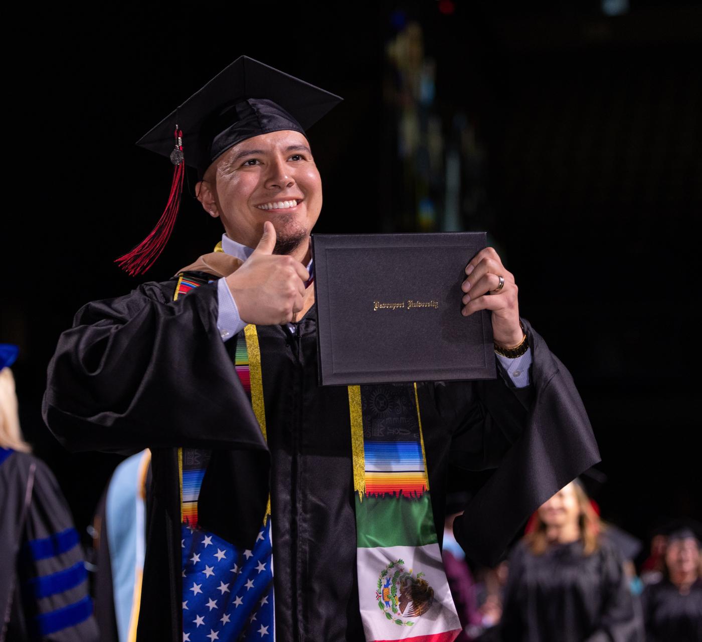 Male Casa Latina graduate student at Commencement