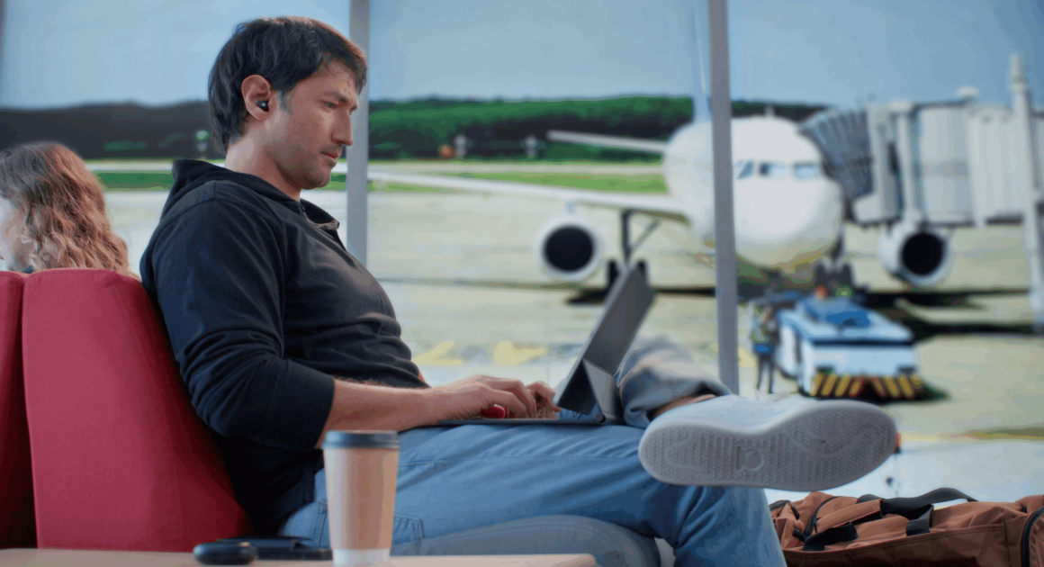 Man in an airport on his laptop